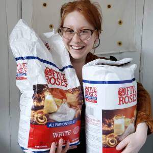 Red head holding two big bags of four